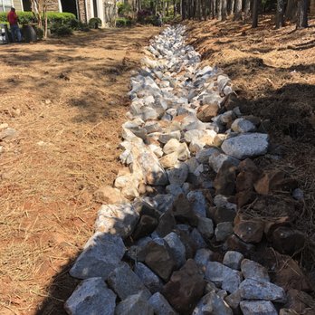 Ampro Excavation - a dry creek bed of rocks in front of a house - Excavation Services Near Me - Villa Rica, Georgia Ampro Excavation - a dry creek bed of rocks in front of a house - Excavation Services Near Me - Villa Rica, Georgia