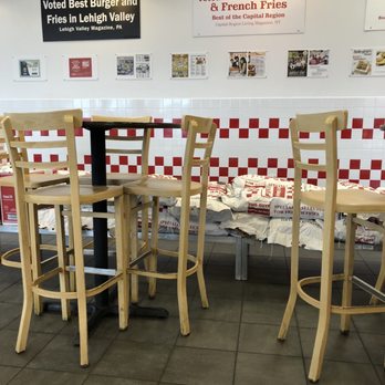 Five Guys - a table and chairs in a restaurant - Burgers Near Me - Monroeville, Pennsylvania