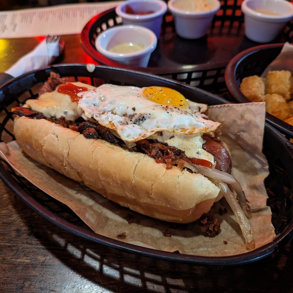 Happy Dog - Fried egg, beer cheese, mushrooms, caramelized onions, bacon, ketchup and ballpark mustard - Bars Near Me - Cleveland, Ohio Happy Dog - Fried egg, beer cheese, mushrooms, caramelized onions, bacon, ketchup and ballpark mustard - Bars Near Me - Cleveland, Ohio