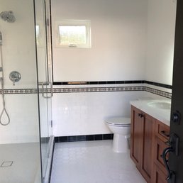 a bathroom with a toilet, shower, and sink