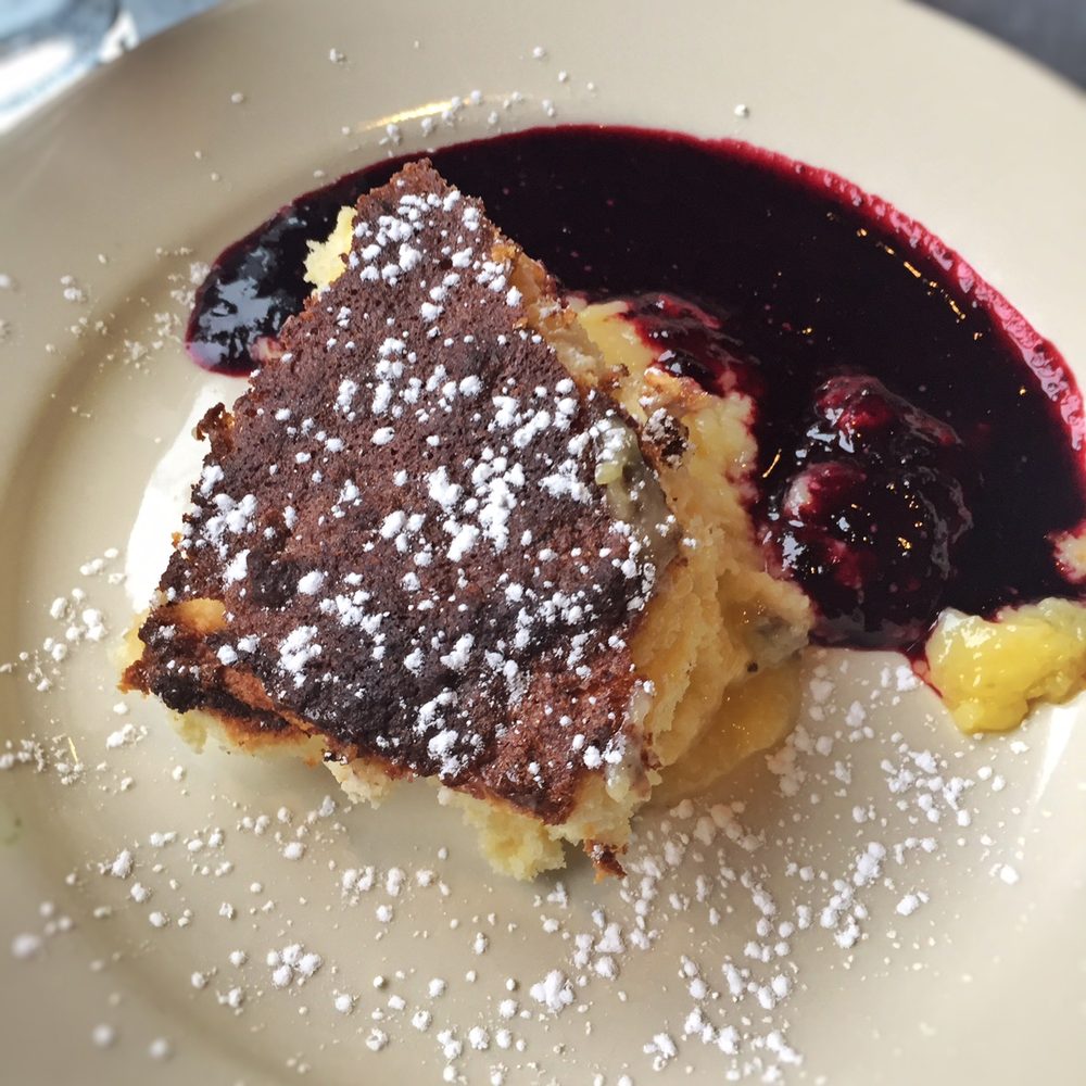 The Red Dory - Lemon-buttermilk pudding with huckleberry sauce - New American Near Me - Tiverton, Rhode Island