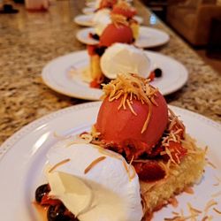 Berry Shortcake, Lemon Olive Oil Cake, Raspberry Sorbet, Whipped Coconut Cream, Toasted Coconut.