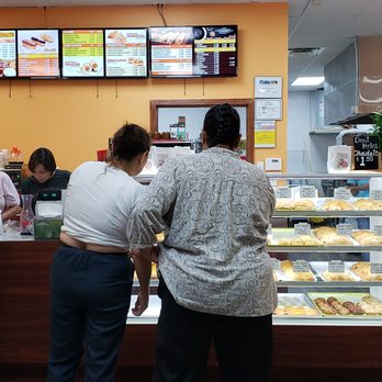 Bastrop Donuts - a group of people at a counter - Donuts Near Me - Bastrop, Texas