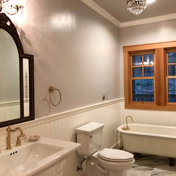John Allen Construction - a bathroom with a tub, toilet, and sink - General Contractors Near Me
