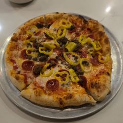 Cheese pizza with pepperoni, beef, and banana peppers.