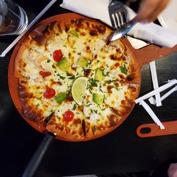 The Lauber - two pizzas on a table with utensils - Bars Near Me - South Bend, Indiana The Lauber - two pizzas on a table with utensils - Bars Near Me - South Bend, Indiana