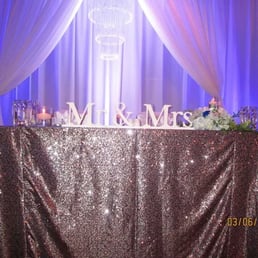 Our sweetheart table dressed in silver sequins (new inventory), pipe and draping with chandelier Our sweetheart table dressed in silver sequins (new inventory), pipe and draping with chandelier