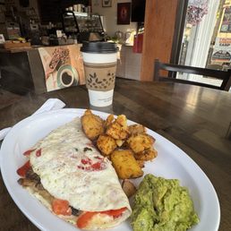 Egg whites omelette with mixed veggies, and Swiss cheese, a side avocado and home fries.