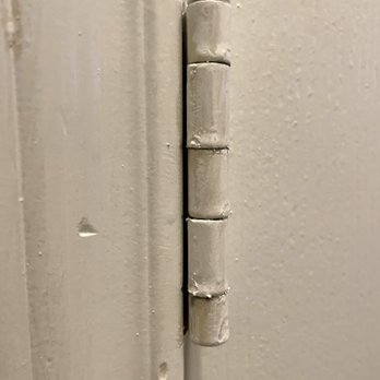 Hill Country Painting - Pic shows very sloppy paint job of door hinge in our downstairs bathroom (pic taken 09/02/22) - Painters Near Me - Pflugerville, Texas