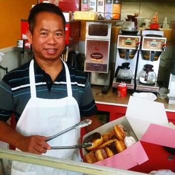 Jenny's Donuts - Randy carefully selecting a box full of freshly made Jenny's Donuts for a customer. - Donuts Near Me - Redlands, California Jenny's Donuts - Randy carefully selecting a box full of freshly made Jenny's Donuts for a customer. - Donuts Near Me - Redlands, California