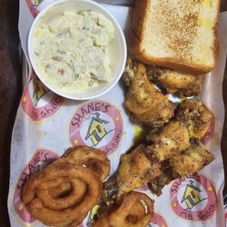 Shane's Rib Shack - Lemon pepper wings, onion rings,  and potato salad