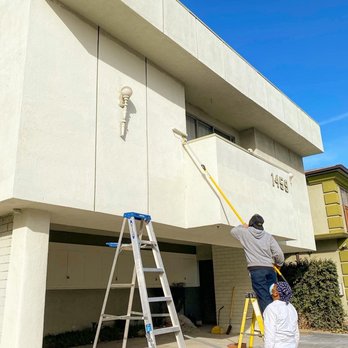 Zebra Construction - a man on a ladder painting a building - General Contractors Near Me - Los Angeles, California Zebra Construction - a man on a ladder painting a building - General Contractors Near Me - Los Angeles, California