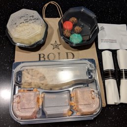 Wedding tasting leftovers packed up neat and nicely for us in a to-go bag. They even included eating utensils and napkins.