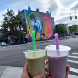 two people holding drinks in their hands