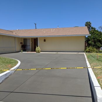 Kal-Crete Construction - a concrete driveway with a yellow caution tape - General Contractors Near Me - Thousand Oaks, California Kal-Crete Construction - a concrete driveway with a yellow caution tape - General Contractors Near Me - Thousand Oaks, California