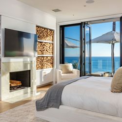 Carrara - Oceanfront master suite with cozy fireplace, luxury linens, and private terrace access offering ultimate comfort during treatment.