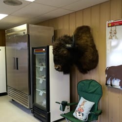 SB Farms - Meat freezer (silver), refrigerator & mounted buffalo trophy.