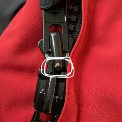 Tres Bon Dry Cleaners - White circle: Zipper surface damage