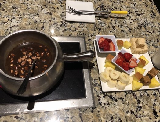 Photo of The Melting Pot - Arlington, TX, US. Flaming turtle with milk chocolate and candied pecans