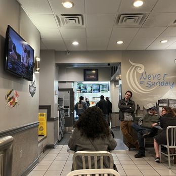 Never On Sunday - people sitting in a waiting area - Greek Near Me - Baltimore, Maryland Never On Sunday - people sitting in a waiting area - Greek Near Me - Baltimore, Maryland