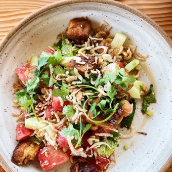 Proud Mary - a plate of food on a wooden table - Breakfast & Brunch Near Me - Austin, Texas