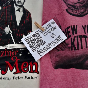 Grand Bazaar NYC - Love this T shirt stand. Lennon's famous pose but with cat - Flea Markets Near Me - New York, New York