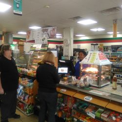 7-Eleven - There are just a few people waiting in line.