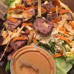 BBQ ranch salad with steak and dressing on side.