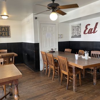 Star Pizza - a dining room with wooden tables and chairs - Pizza Near Me - Houston, Texas