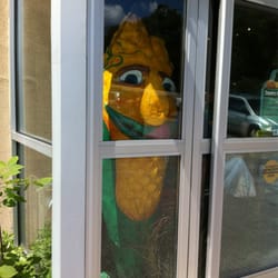 Country Produce - Creepy papier mâché corn person greeting customers at the door. It's corn season! The corn from here is amazingly delicious, btw