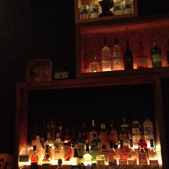 The Bends - a shelf of liquor bottles and candles - Bars Near Me - Saint Petersburg, Florida The Bends - a shelf of liquor bottles and candles - Bars Near Me - Saint Petersburg, Florida