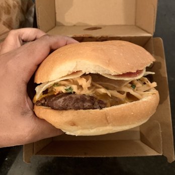 Yeg Burger - a hand holding a hamburger - Burgers Near Me - Edmonton, Alberta