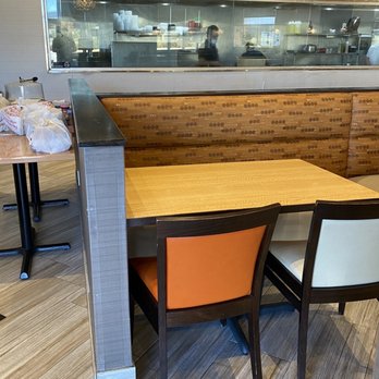 Saravanaa Bhavan - a table and chairs in a restaurant - Indian Near Me - Irving, Texas Saravanaa Bhavan - a table and chairs in a restaurant - Indian Near Me - Irving, Texas