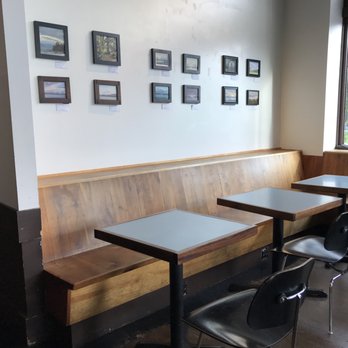 Cupcake Royale - tables and benches in a restaurant - Bakeries Near Me - Seattle, Washington