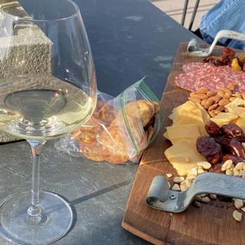 Presqu'ile Winery - Relaxing with a Glass of Chardonnay and enjoying some tasty treats. - Wineries Near Me - Santa Maria, California