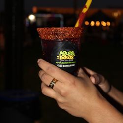 Small Green Tea Hibiscus topped with our house chamoy, tajin and tamarind straw.