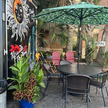 Coffee Ave - a table and chairs with an umbrella - Coffee & Tea Near Me - Fort Walton Beach, Florida