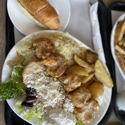 Zet’s - Chicken Souvlaki Dinner includes dinner roll, side of rice and potatoes and salad.