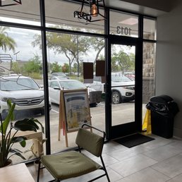 Entrance area of Bestea cafe with thin green cushioned chairs accented black. Entrance area of Bestea cafe with thin green cushioned chairs accented black.