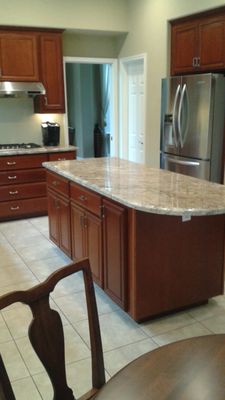 Kitchen Cabinets Refaced with Cherrywood - Customer had very large kitchen with good configuration. They wanted an elegant wood look without the cost of brand-new custom cabinets. We decided to reface in cherry with a medium dark stain.