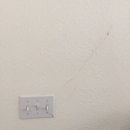 Broken light switch and scratched up wall from the movers