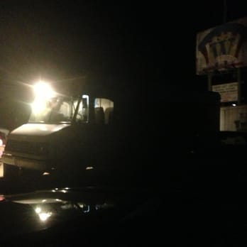 Tacos El Trailero - a group of people sitting at a table in the dark - Mexican Near Me - Von Ormy, Texas Tacos El Trailero - a group of people sitting at a table in the dark - Mexican Near Me - Von Ormy, Texas