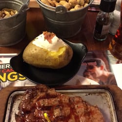 Roadhouse Grill - Ribeye and loaded baked potato. They even have the peanuts.