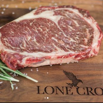 Lone Crow Ranch - a piece of steak on a cutting board - Meat Shops Near Me - Loon Lake, Washington Lone Crow Ranch - a piece of steak on a cutting board - Meat Shops Near Me - Loon Lake, Washington