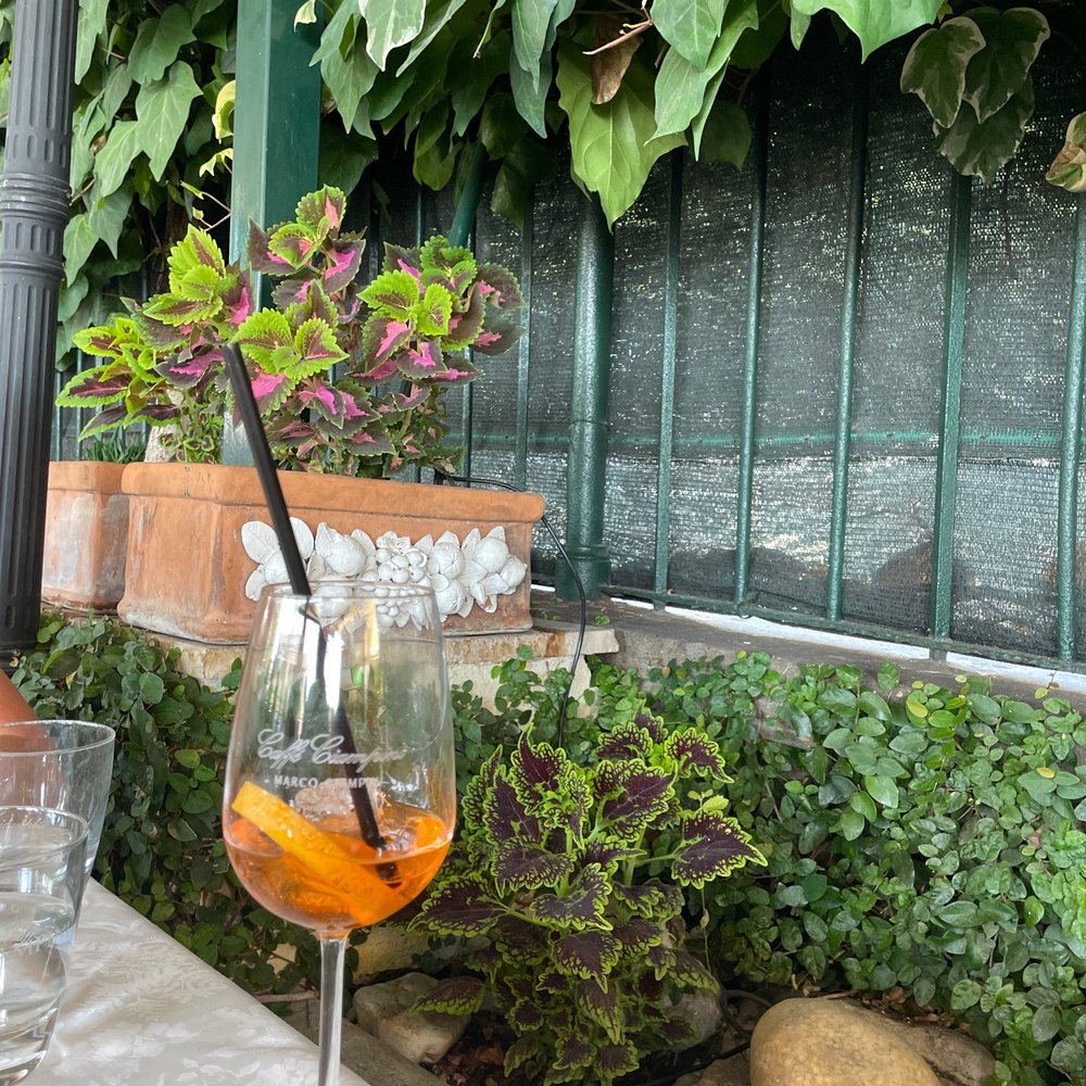 Garden patio dining, lovely breeze, with a well enjoyed aperol spritz Garden patio dining, lovely breeze, with a well enjoyed aperol spritz