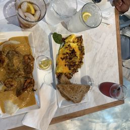 Catfish shrimp grits, omelette with cheese, vegetables, turkey, bacon, sweet tea, water