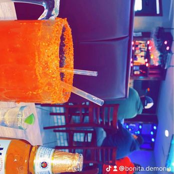 Los Dos Carnales Restaurant - an orange drink with a straw - Mexican Near Me - Myrtle Beach, South Carolina