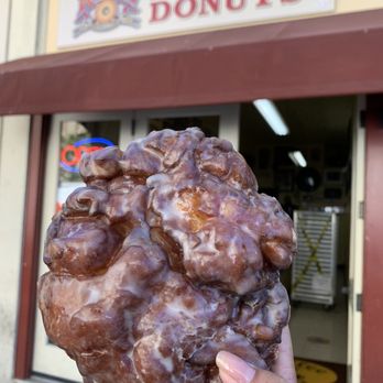 Red's Donuts - a hand holding a doughnut - Donuts Near Me - Monterey, California Red's Donuts - a hand holding a doughnut - Donuts Near Me - Monterey, California