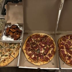 Velarde Pizza and Daiquiris Togo - Chicken/jalapeños (Alfredo sauce), meat lovers, pepp/canadian bacon and buffalo wings in the back