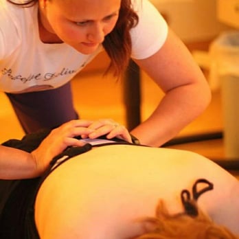 Utah Doula Services - Karina Robinson providing counter-pressure through a birthing wave. - Doulas Near Me